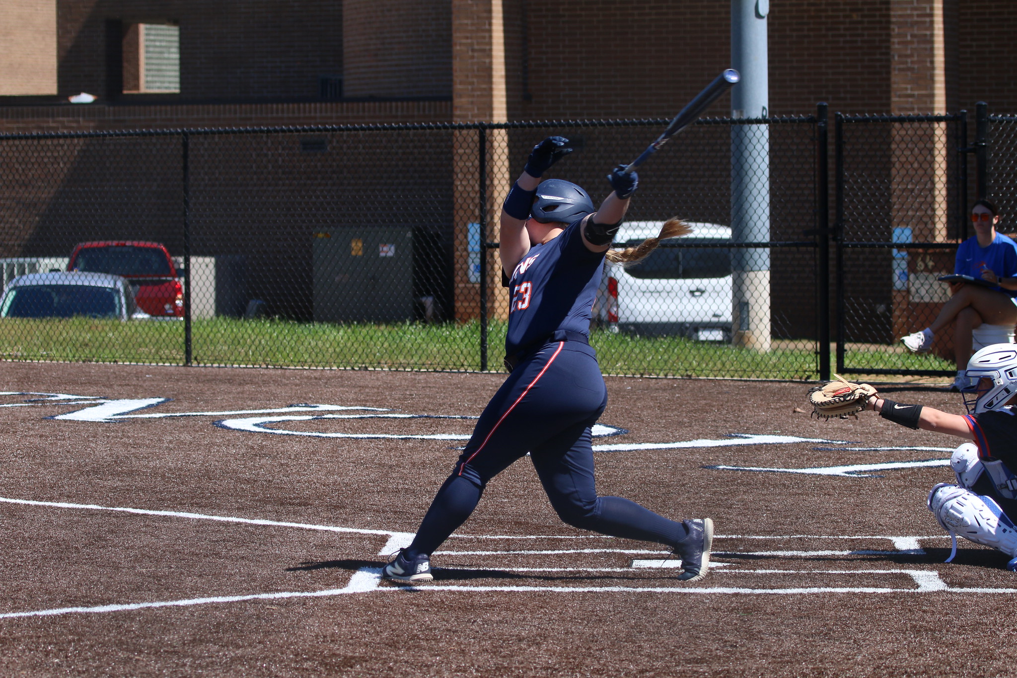 softball player swings